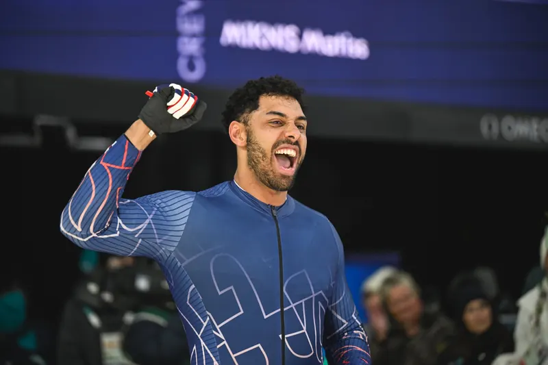 Leon Greenwood in a Team GB race suit, fist raised in celebration