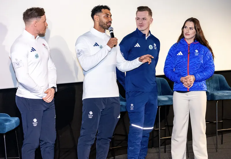 Leon Greenwood speaking on stage alongside three fellow Team GB athletes